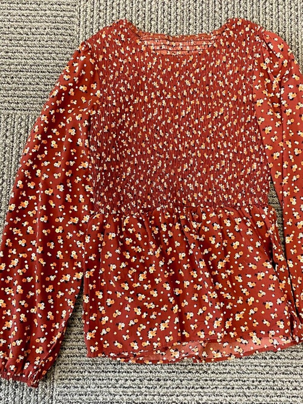 Ruched floral peplum top, satiny fabric.
